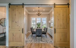 Exquisite dining room with double barn door entrance